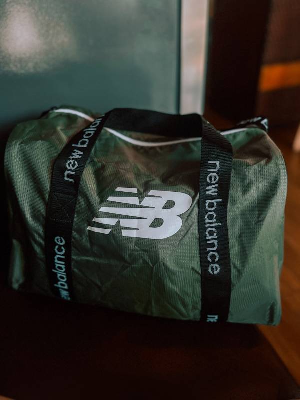 a green bag sitting on top of a wooden table