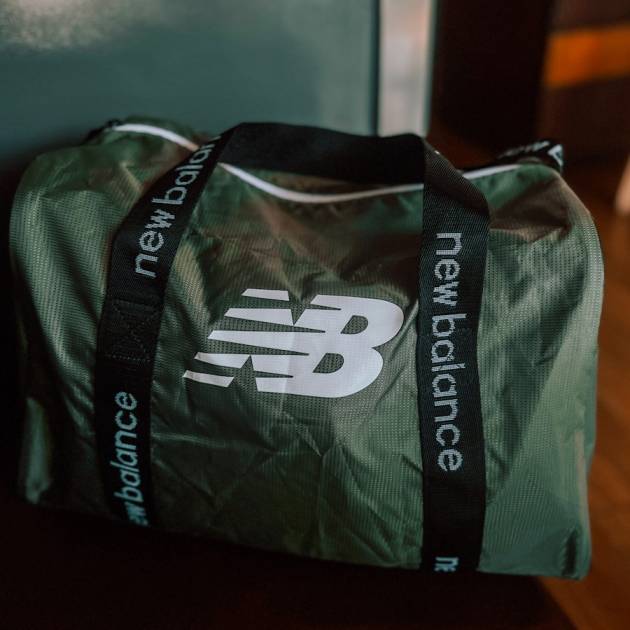 a green bag sitting on top of a wooden table