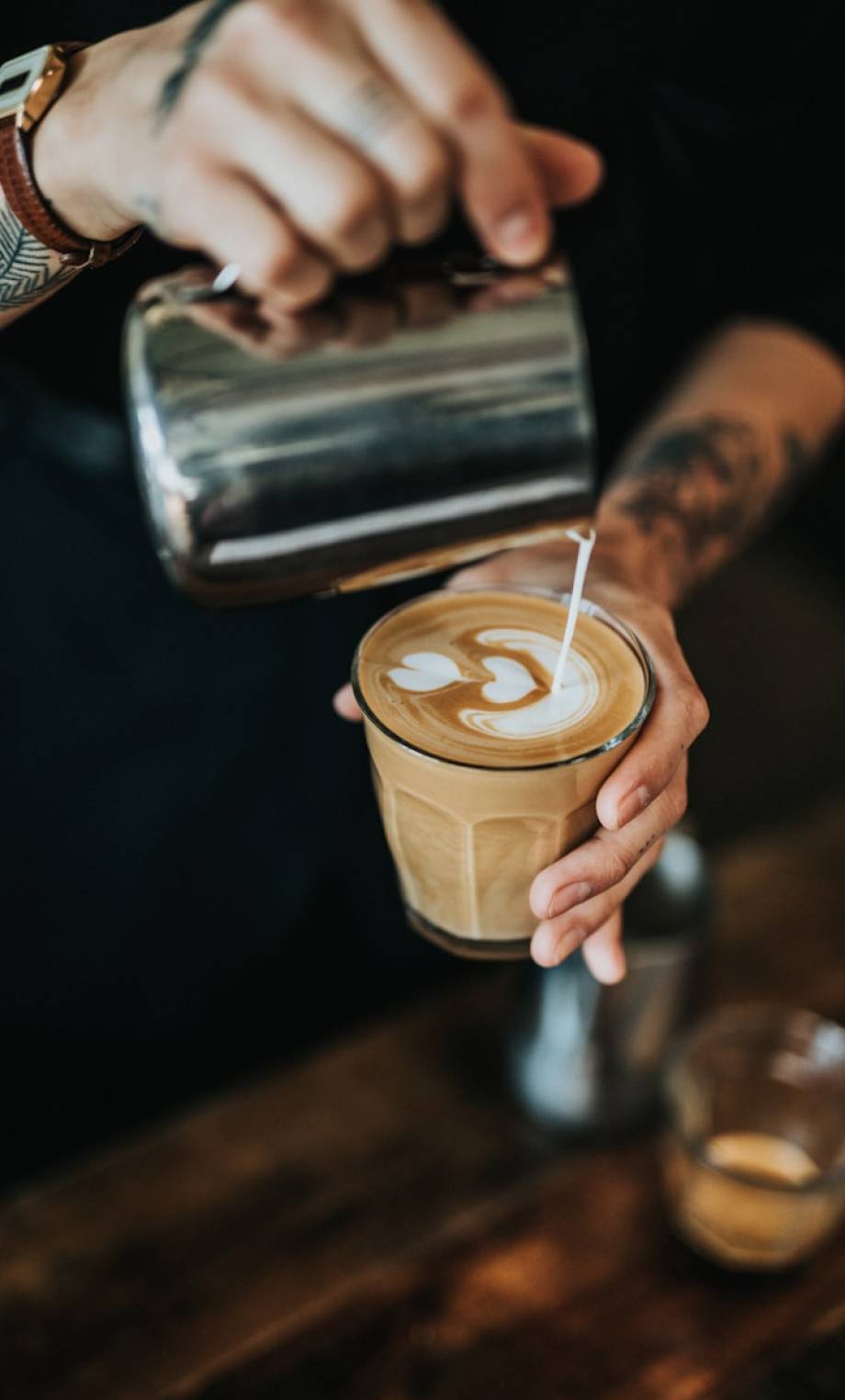 Photo by Nathan Dumlao man pouring milk in coffee