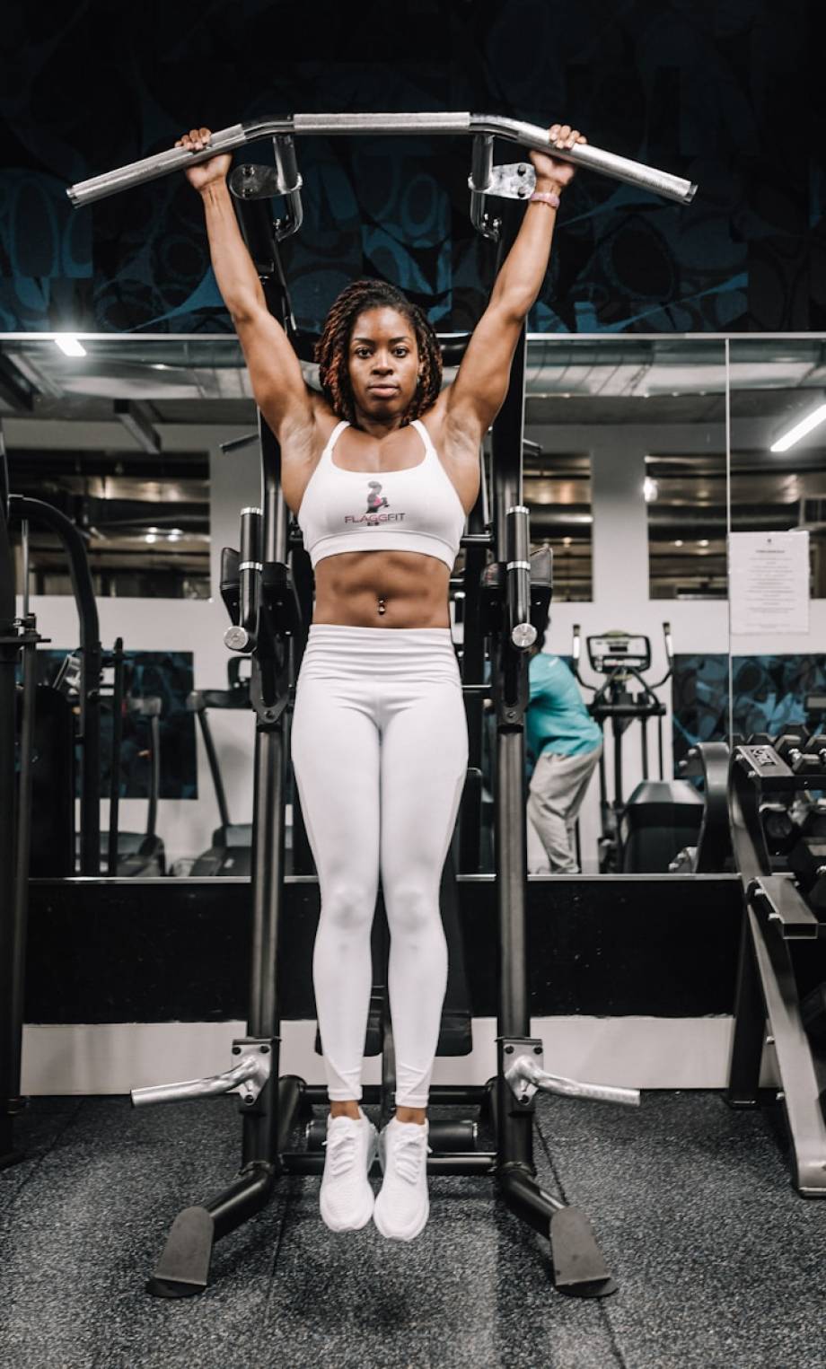 Photo by Osarodion Amenze woman in white tank top and white pants doing exercise